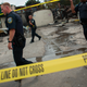 Police officers patrol the BP gas station following a shooting death by police August 15, 2016 in Milwaukee, Wisconsin.